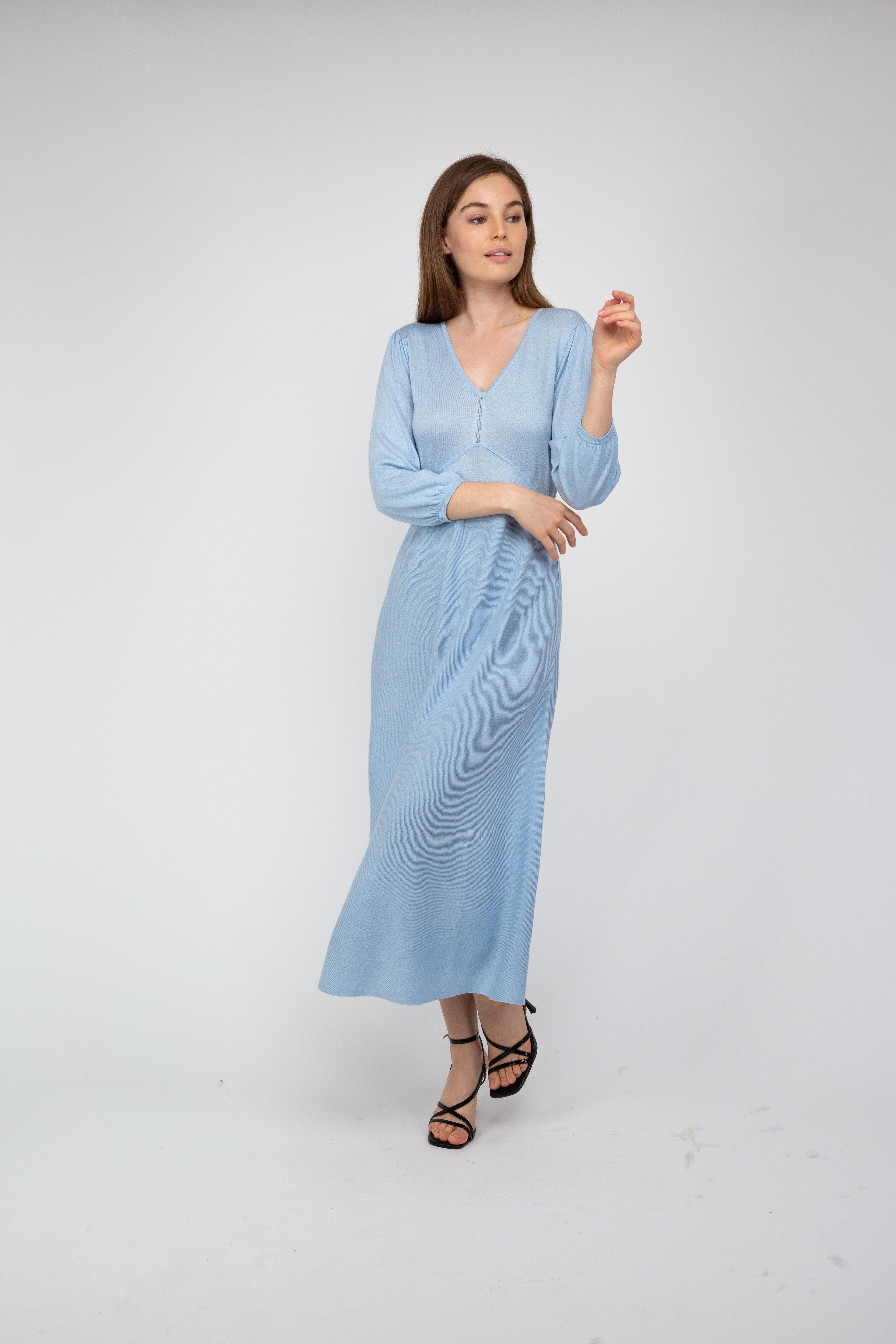 Woman wearing a light blue dress on a white background